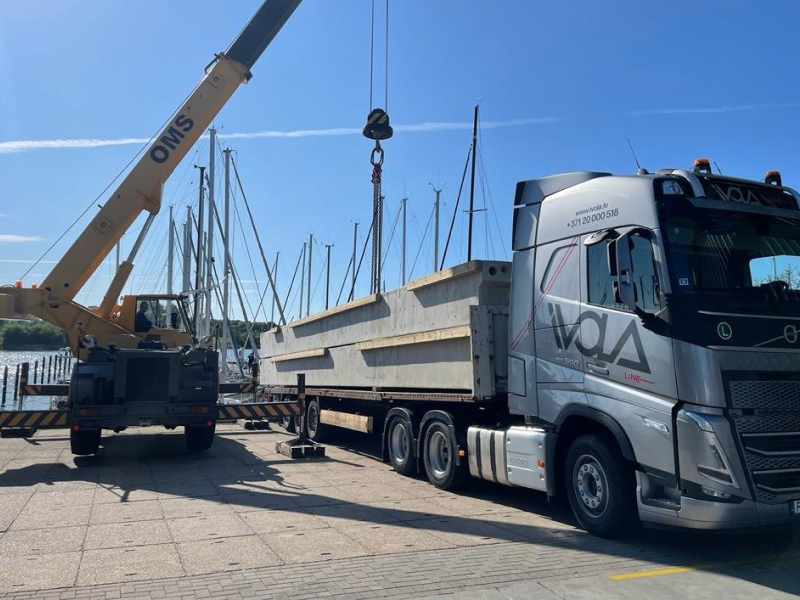 A heavy truck is being loaded with cargo.