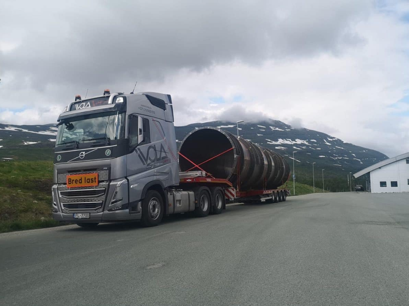 A heavy truck is delivering oversized cargo.