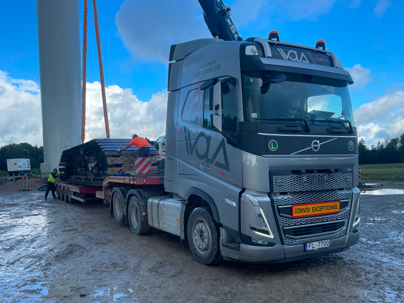 A heavy truck is being loaded with cargo.